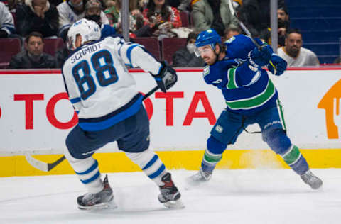 Vancouver Canucks, Conor Garland (8), Winnipeg Jets, Nate Schmidt (88). Mandatory Credit: Bob Frid-USA TODAY Sports