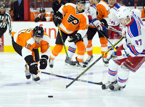 Sep 22, 2015; Philadelphia, PA, USA; Philadelphia Flyers center Brayden Schenn (10) attempts to poke check the puck from New York Rangers defenseman Mat Bodie (87) during the second period at Wells Fargo Center. Mandatory Credit: Bill Streicher-USA TODAY Sports