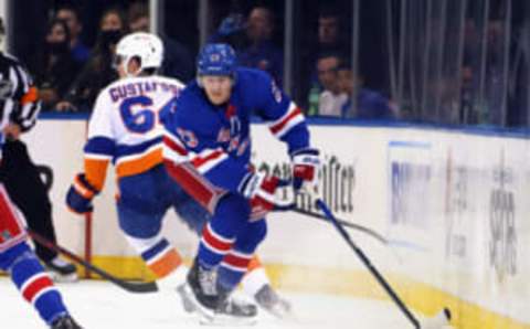 NEW YORK, NEW YORK – SEPTEMBER 26: Adam Fox #23 of the New York Rangers carries the puck against the New York Islanders during the first period in a preseason game at Madison Square Garden on September 26, 2021 in New York City. (Photo by Bruce Bennett/Getty Images)