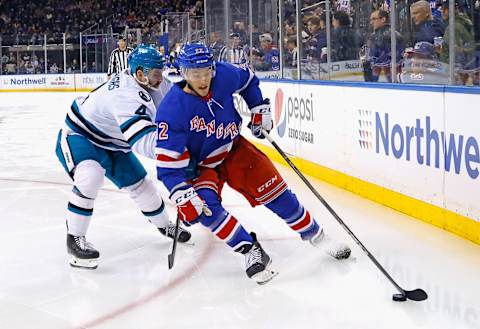 NEW YORK, NEW YORK – DECEMBER 03: Jonny Brodzinski #22 of the New York Rangers carries the puck against Kyle Burroughs #4 of the San Jose Sharks during the second period at Madison Square Garden on December 03, 2023 in New York City. (Photo by Bruce Bennett/Getty Images)