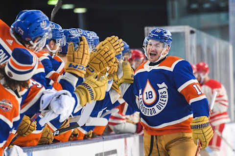 EDMONTON, CANADA – OCTOBER 29: Zach Hyman #18 of the Edmonton Oilers celebrates with the bench after scoring the team`s second goal against the Calgary Flames during the first period of the 2023 Tim Hortons NHL Heritage Classic at Commonwealth Stadium on October 29, 2023 in Edmonton, Alberta, Canada. (Photo by Derek Leung/Getty Images)