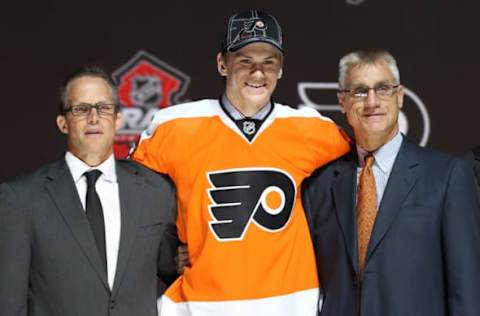 Jun 30, 2013; Newark, NJ, USA; Samuel Morin poses for a photo with team officials after being introduced as the number eleven overall pick to the Philadelphia Flyers during the 2013 NHL Draft at the Prudential Center. Mandatory Credit: Ed Mulholland-USA TODAY Sports