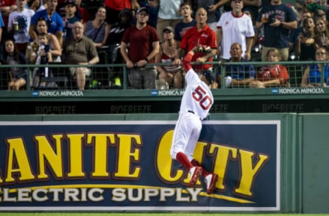 BOSTON, MA – JULY 10: Mookie Betts #50 of the Boston Red Sox leaps over the wall to rob a home run ball during the fifth inning of a game against the Texas Rangers on July 10, 2018 at Fenway Park in Boston, Massachusetts. (Photo by Billie Weiss/Boston Red Sox/Getty Images)