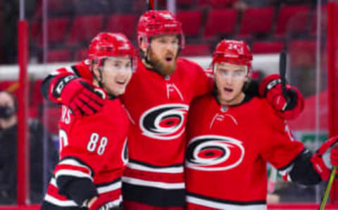 Apr 17, 2021; Raleigh, North Carolina, USA; Carolina Hurricanes defenseman Jani Hakanpaa (58) celebrates his third period goal with center Martin Necas (88) and right wing Sebastian Aho (20) against the Nashville Predators at PNC Arena. Mandatory Credit: James Guillory-USA TODAY Sports