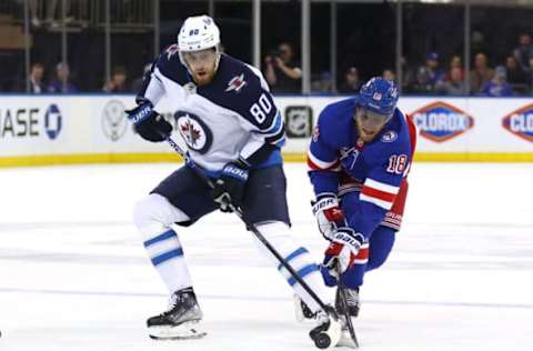 NEW YORK, NEW YORK – APRIL 19: Andrew Copp #18 of the New York Rangers steals the puck from Pierre-Luc Dubois #80 of the Winnipeg Jets during the first period at Madison Square Garden on April 19, 2022 in New York City. (Photo by Elsa/Getty Images)