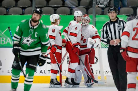 Feb 11, 2021; Dallas, Texas, USA; Carolina Hurricanes center Ryan Dzingel (18) and defenseman Haydn Fleury (4) and goaltender James Reimer (47) celebrate the win over the Dallas Stars at the American Airlines Center. Mandatory Credit: Jerome Miron-USA TODAY Sports