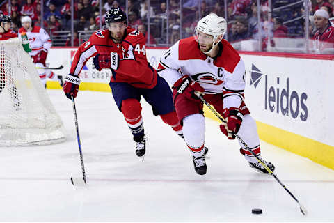 WASHINGTON, DC – MARCH 30: Jordan Staal #11 of the Carolina Hurricanes and Brooks Orpik #44 of the Washington Capitals battle for the puck in the second period at Capital One Arena on March 30, 2018 in Washington, DC. (Photo by Patrick McDermott/NHLI via Getty Images)