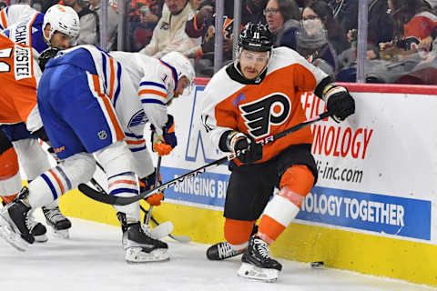 Oct 19, 2023; Philadelphia, Pennsylvania, USA; Edmonton Oilers defenseman Mattias Ekholm (14) and Philadelphia Flyers right wing Travis Konecny (11) battle for the puck during the first period at Wells Fargo Center. Mandatory Credit: Eric Hartline-USA TODAY Sports