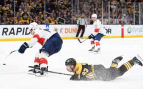 Apr 30, 2023; Boston, Massachusetts, USA; Boston Bruins left wing Brad Marchand (63) gets tripped up while Florida Panthers left wing Matthew Tkachuk (19) skates after the loose puck during the first period in game seven of the first round of the 2023 Stanley Cup Playoffs at TD Garden. Mandatory Credit: Bob DeChiara-USA TODAY Sports