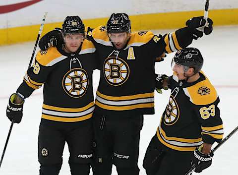 BOSTON – NOVEMBER 10: Boston Bruins’ Patrice Bergeron, center, celebrates his first period goal with teammates David Pastrnak and Brad Marchand. The Boston Bruins host the Toronto Maple Leafs in a regular season NHL hockey game at TD Garden in Boston on Nov. 10, 2018. (Photo by John Tlumacki/The Boston Globe via Getty Images)