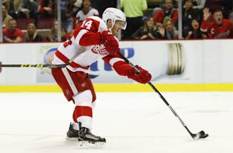 Oct 21, 2016; Detroit, MI, USA; Detroit Red Wings right wing Gustav Nyquist (14) takes a shot in the third period against Nashville Predators at Joe Louis Arena. Detroit won 5-3. Mandatory Credit: Rick Osentoski-USA TODAY Sports