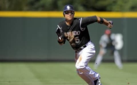 DENVER, CO – SEPTEMBER 10: Carlos Gonzalez #5 of the Colorado Rockies runs against the Cincinnati Reds at Coors Field on September 10, 2011 in Denver, Colorado. (Photo by Jack Dempsey/Getty Images)