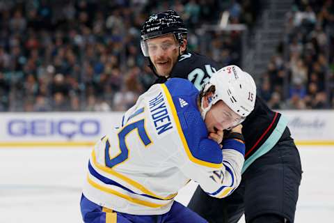 SEATTLE, WASHINGTON – NOVEMBER 04: John Hayden #15 of the Buffalo Sabres and Jamie Oleksiak #24 of the Seattle Kraken fight during the first period on November 04, 2021 at Climate Pledge Arena in Seattle, Washington. (Photo by Steph Chambers/Getty Images)