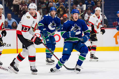 Apr 19, 2022; Vancouver, British Columbia, CAN; Ottawa Senators defenseman Travis Hamonic (23) looks on as Vancouver Canucks forward Brock Boeser (6) celebrates his goal in the first period at Rogers Arena. Mandatory Credit: Bob Frid-USA TODAY Sports