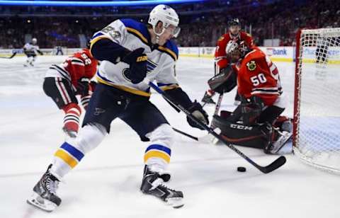 Jan 24, 2016; Chicago, IL, USA; St. Louis Blues right wing Dmitrij Jaskin (23) shoots the puck against Chicago Blackhawks goalie Corey Crawford (50) during the second period at the United Center. Mandatory Credit: Mike DiNovo-USA TODAY Sports