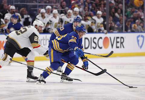 Mar 10, 2022; Buffalo, New York, USA; Buffalo Sabres center Cody Eakin (20) reaches for the puck as Vegas Golden Knights center Michael Amadio (22) defends during the second period at KeyBank Center. Mandatory Credit: Timothy T. Ludwig-USA TODAY Sports