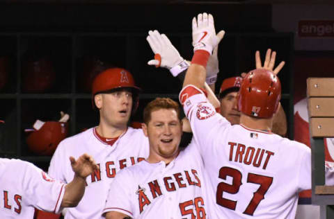 Sep 26, 2016; Anaheim, CA, USA; Los Angeles Angels center fielder Mike Trout (27) gets a high five from first baseman C.J. Cron (24) and right fielder Kole Calhoun (56) after a solo home run in the fourth of the game against the Oakland Athletics at Angel Stadium of Anaheim. Mandatory Credit: Jayne Kamin-Oncea-USA TODAY Sports