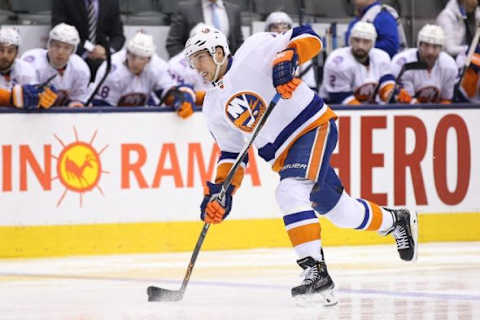 Mar 9, 2015; Toronto, Ontario, CAN; New York Islanders defenseman Travis Hamonic (3) shoots the puck against the Toronto Maple Leafs at Air Canada Centre. The Islanders beat the Maple Leafs 4-3 in overtime. Mandatory Credit: Tom Szczerbowski-USA TODAY Sports