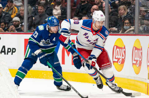 VANCOUVER, BC – NOVEMBER 2: Oliver Ekman-Larsson #23 of the Vancouver Canucks tries to check Chris Kreider #20 of the New York Rangers off the puck during NHL action on November 2, 2021, at Rogers Arena in Vancouver, British Columbia, Canada. (Photo by Rich Lam/Getty Images)