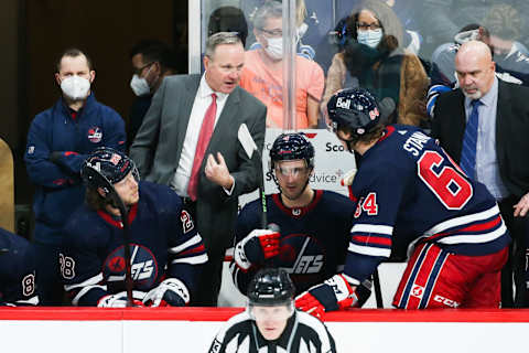 Winnipeg Jets, Dave Lowry; Logan Stanley (64). Mandatory Credit: Terrence Lee-USA TODAY Sports