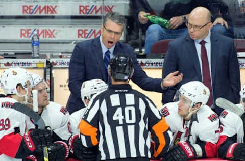 Oct 31, 2015; Ottawa, Ontario, CAN; Ottawa Senators head coach Dave Cameron speaks with referee Steve Kozari (40) in the third period at Canadian Tire Centre. The Red Wings defeated the Senators 5-3. Mandatory Credit: Marc DesRosiers-USA TODAY Sports