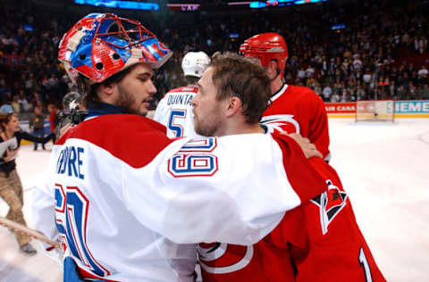 MONTREAL, CAN – MAY 13: Goaltenders Jose Theodore #60 and Arturs Irbe #1 of the Carolina Hurricanes take part in the traditional handshake after game six of the Eastern Conference Semifinal series of the NHL Stanley Cup Playoffs between the Carolina Hurricanes and the Montreal Canadiens at the Molson Centre in Montreal, Canada on May 13, 2002. The Hurricanes won the game 8-2. (Photo by Dave Sandford/Getty Images/NHLI)