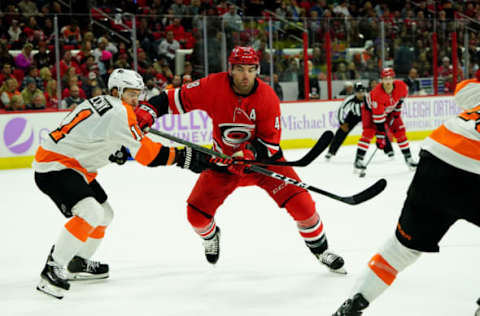 RALEIGH, NC – NOVEMBER 21: Jordan Martinook #48 of the Carolina Hurricanes battles for position on the ice with Travis Konecny #11 of the Philadelphia Flyers during an NHL game on November 21, 2019 at PNC Arena in Raleigh, North Carolina. (Photo by Gregg Forwerck/NHLI via Getty Images)