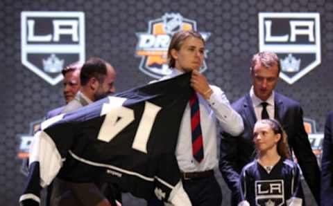 Jun 27, 2014; Philadelphia, PA, USA; Adrian Kempe puts on a team sweater after being selected as the number twenty-nine overall pick to the Los Angeles Kings in the first round of the 2014 NHL Draft at Wells Fargo Center. Mandatory Credit: Bill Streicher-USA TODAY Sports