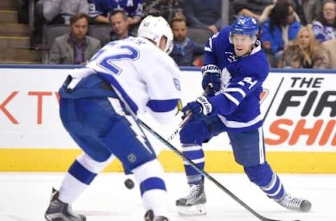 Oct 25, 2016; Toronto, Ontario, CAN; Toronto Maple Leafs forward Peter Holland (24) takes a shot against Tampa Bay Lightning defenseman Andrej Sustr (62) in the second period at Air Canada Centre. Mandatory Credit: Dan Hamilton-USA TODAY Sports