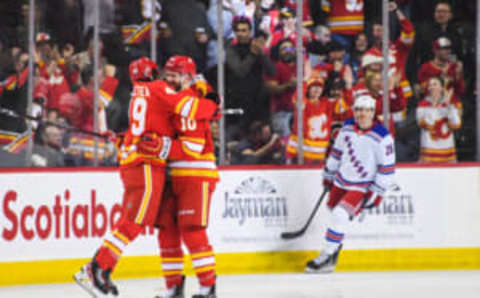 CALGARY, CANADA – FEBRUARY 18: Jakob Pelletier #49 (L) and Jonathan Huberdeau #10 of the Calgary Flames celebrate after their second goal by Nazem Kadri #91 against the New York Rangers during the first period of an NHL game at Scotiabank Saddledome on February 18, 2023 in Calgary, Alberta, Canada. (Photo by Derek Leung/Getty Images)