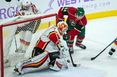 Nov 15, 2016; Saint Paul, MN, USA; Calgary Flames goalie Chad Johnson (31) makes a save on Minnesota Wild forward Mikael Granlund (64) during the third period at Xcel Energy Center. The Flames defeated the Wild 1-0. Mandatory Credit: Brace Hemmelgarn-USA TODAY Sports