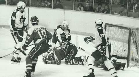 CANADA – FEBRUARY 05: All eyes on the puck: Jim Korn (20); Bill Kitchen (26) an Al lafrate (33) of the Maple Leafs look to the net; where the puck shot by Washington’s Mike McEwen settles behind goaltender Tim Bernhardt. It was the Capitals’ first goal; coming in the first period. Kitchen has Gaetan Duchesne pinned on the ice; while Bobby Carpenter cruises through the slot. The Caps had lost only one of their previous eight games against Toronto. (Photo by Colin McConnell/Toronto Star via Getty Images)