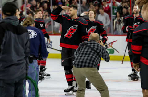 RALEIGH, NC – JANUARY 19: Carolina Hurricanes Right Wing Justin Williams (14) salutes the crowd and to show respect for the military after scoring the game winning goal during a shootout on Military Night during an NHL game between the Carolina Hurricanes and New York Islanders on January 19, 2020 at the PNC Arena in Raleigh, NC. (Photo by John McCreary/Icon Sportswire via Getty Images)