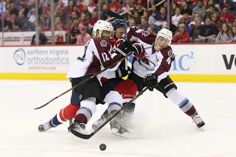 Oct 18, 2016; Washington, DC, USA; Washington Capitals center Jay Beagle (83) battles for the puck with Colorado Avalanche right wing Jarome Iginla (12) and Avalanche defenseman Tyson Barrie (4) in the first period at Verizon Center. The Capitals won 3-0. Mandatory Credit: Geoff Burke-USA TODAY Sports