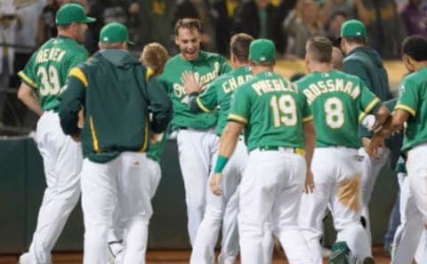 OAKLAND, CA – JULY 30: Matt Olson #28 of the Oakland Athletics and his teammates celebrate after Olson hit a walk-off solo home run in the bottom of the 10th inning to defeat the Milwaukee Brewers 3-2 at Ring Central Coliseum on July 30, 2019 in Oakland, California. (Photo by Thearon W. Henderson/Getty Images)