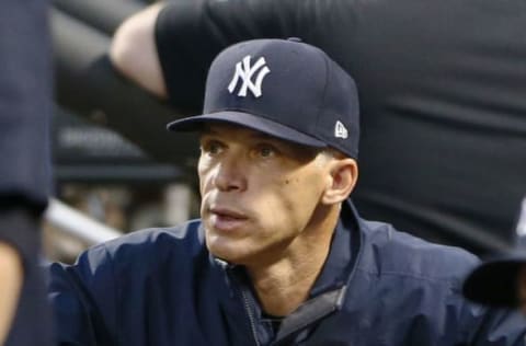 NEW YORK, NY – SEPTEMBER 12: Manager Joe Girardi #28 of the New York Yankees watches his team from the dugout during an MLB baseball game against the Tampa Bay Rays on September 12, 2017 at CitiField in the Queens borough of New York City. This game was scheduled to be played in Tampa Bay, but had to be moved to play in a neutral stadium because of hurricane damage in Florida. Rays won 2-1. (Photo by Paul Bereswill/Getty Images)