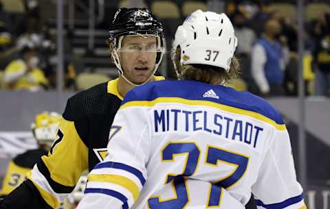 May 8, 2021; Pittsburgh, Pennsylvania, USA; Pittsburgh Penguins center Jeff Carter (77) and Buffalo Sabres center Casey Mittelstadt (37) talk before a face-off during the third period at PPG Paints Arena. The Pens won 1-0. Mandatory Credit: Charles LeClaire-USA TODAY Sports