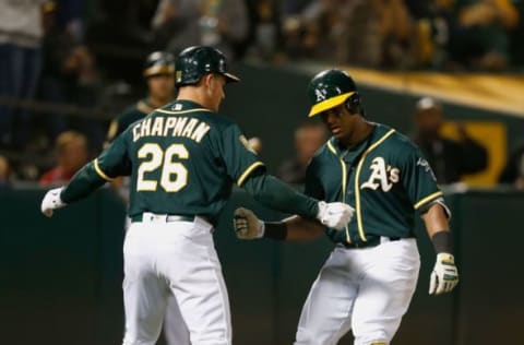 OAKLAND, CA – AUGUST 07: Khris Davis #2 of the Oakland Athletics celebrates with teammate Matt Chapman #26 after hitting a two-run home run in the sixth inning against the Los Angeles Dodgers at Oakland Alameda Coliseum on August 7, 2018 in Oakland, California. (Photo by Lachlan Cunningham/Getty Images)