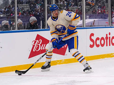 Mar 13, 2022; Hamilton, Ontario, CAN; Buffalo Sabres forward Dylan Cozens (24) controls the puck against the Toronto Maple Leafs in the 2022 Heritage Classic ice hockey game at Tim Hortons Field. Mandatory Credit: John E. Sokolowski-USA TODAY Sports