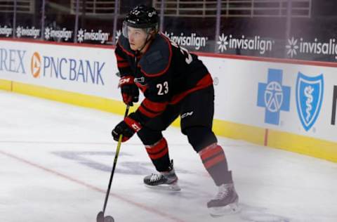 RALEIGH, NORTH CAROLINA – JANUARY 28: Brock McGinn #23 of the Carolina Hurricanes skates with the puck during the first period of their game against the Tampa Bay Lightning at PNC Arena on January 28, 2021 in Raleigh, North Carolina. (Photo by Jared C. Tilton/Getty Images)