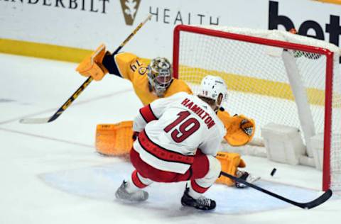 May 27, 2021; Nashville, Tennessee, USA; Carolina Hurricanes defenseman Dougie Hamilton (19) scores the game-tying goal past Nashville Predators goaltender Juuse Saros (74) during the third period in game six of the first round of the 2021 Stanley Cup Playoffs at Bridgestone Arena. Mandatory Credit: Christopher Hanewinckel-USA TODAY Sports