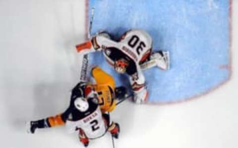 Nov 17, 2015; Nashville, TN, USA; Nashville Predators center Mike Fisher (12) is played off the puck by Anaheim Ducks defenseman Kevin Bieksa (2) while attempting a shot on goalie Anton Khudobin (30) during the second period at Bridgestone Arena. Mandatory Credit: Christopher Hanewinckel-USA TODAY Sports