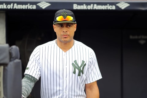 NEW YORK, NY – MAY 27: Giancarlo Stanton #27 of the New York Yankees looks on from the dugout ahead of a game against the Los Angeles Angels at Yankee Stadium on Sunday, May 27, 2018, in the Bronx borough of New York City. (Photo by Alex Trautwig/MLB Photos via Getty Images)