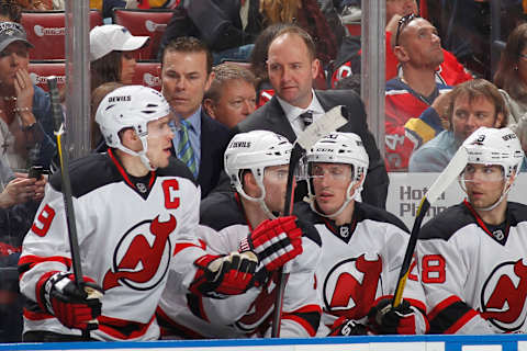 Head coach Peter DeBoer talks to Zach Parise #9 of the New Jersey Devils. (Photo by Joel Auerbach/Getty Images)