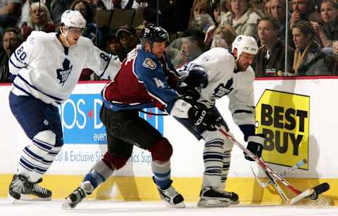 DENVER – JANUARY 17: Jason Allison #41 of the Toronto Maple Leafs and Rob Blake #4 of the Colorado Avalanche battle for the puck as Nik Antropov #80 of the Leafs loses his stick on January 17, 2006 at the Pepsi Center in Denver, Colorado. (Photo by Doug Pensinger/Getty Images)