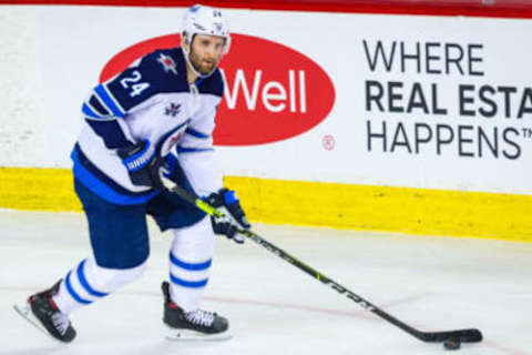 May 5, 2021; Calgary, Alberta, CAN; Winnipeg Jets defenseman Derek Forbort (24) skates with the puck against the Calgary Flames during the third period at Scotiabank Saddledome. Mandatory Credit: Sergei Belski-USA TODAY Sports