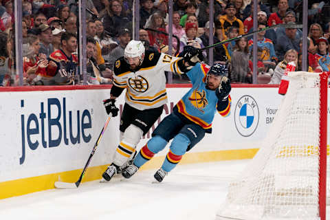 Jan 28, 2023; Sunrise, Florida, USA; Boston Bruins left wing Nick Foligno (17) and Florida Panthers left wing Ryan Lomberg (94) battle for position behind the net during the first period at FLA Live Arena. Mandatory Credit: Jason Mowry-USA TODAY Sports