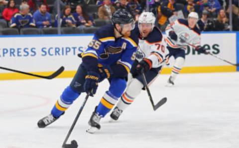 ST LOUIS, MO – NOVEMBER 14: Colton Parayko #55 of the St. Louis Blues controls the puck against Colton Sceviour #70 of the Edmonton Oilers during the second period at Enterprise Center on November 14, 2021 in St Louis, Missouri. (Photo by Dilip Vishwanat/Getty Images)