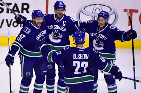 Jan 2, 2017; Vancouver, British Columbia, CAN; Vancouver Canucks forward Sven Baertschi (47) celebrates his goal against Colorado Avalanche goaltender Calvin Pickard (31) (not pictured) with forward Henrik Sedin (33) and forward Daniel Sedin (22) during the third period at Rogers Arena. The Vancouver Canucks won 3-2. Mandatory Credit: Anne-Marie Sorvin-USA TODAY Sports