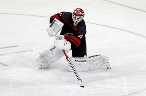 RALEIGH, NORTH CAROLINA – MARCH 04: Alex Nedeljkovic #39 of the Carolina Hurricanes plays the puck during the third period of their game against the Detroit Red Wings at PNC Arena on March 04, 2021 in Raleigh, North Carolina. (Photo by Jared C. Tilton/Getty Images)